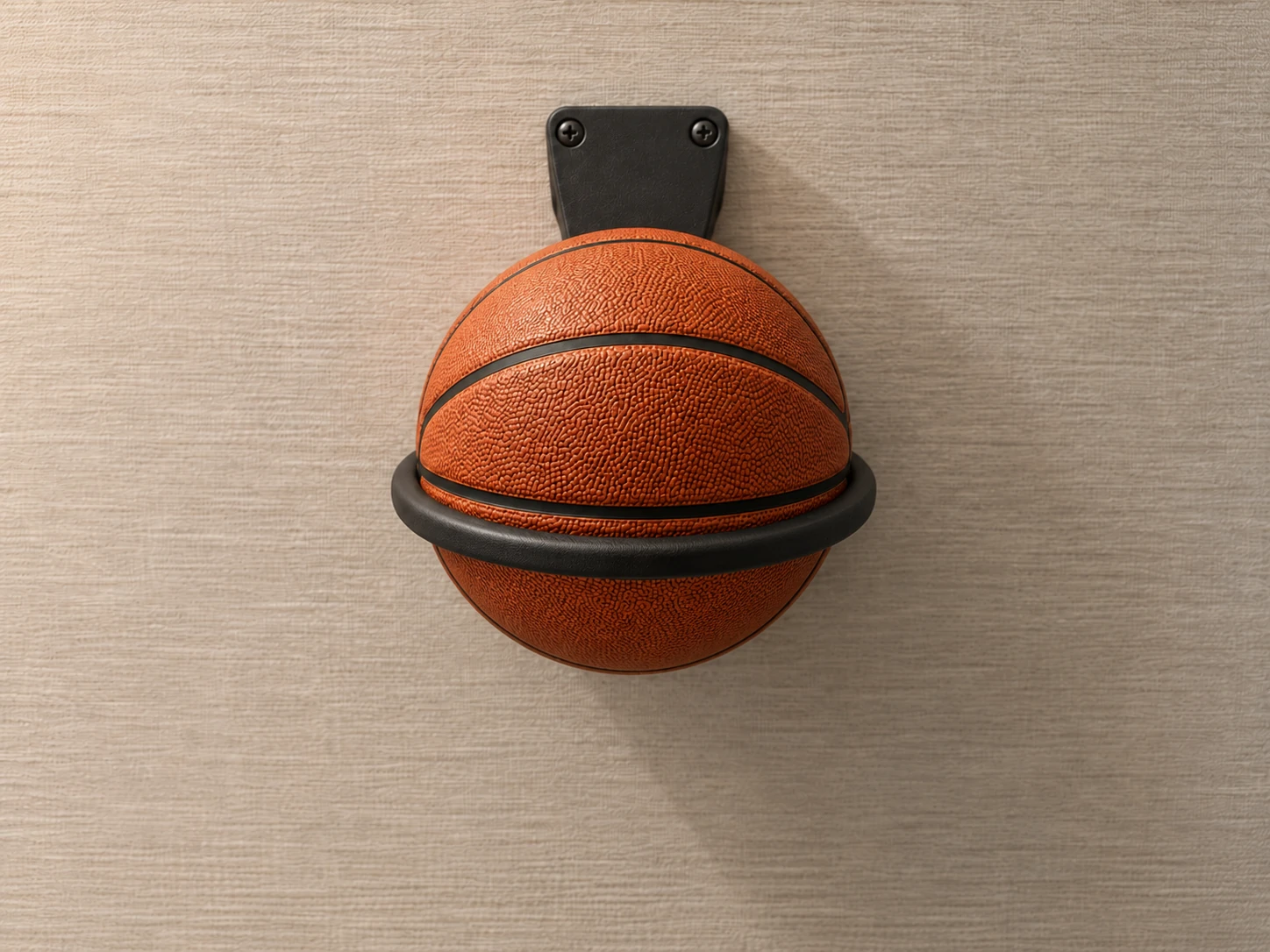 A basketball supported by a custom wall-mounted ring holder in a fitness center.