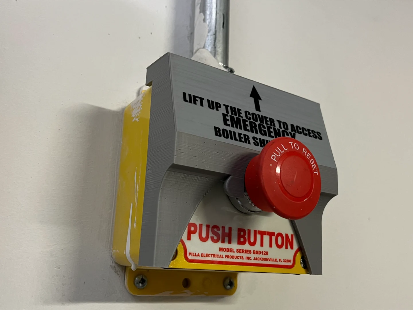 The custom cover installed over a boiler shutoff.